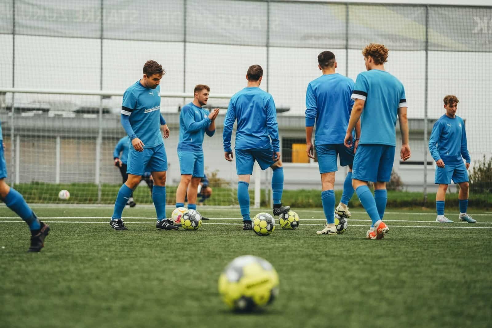 a bunch of soccer players training in the field